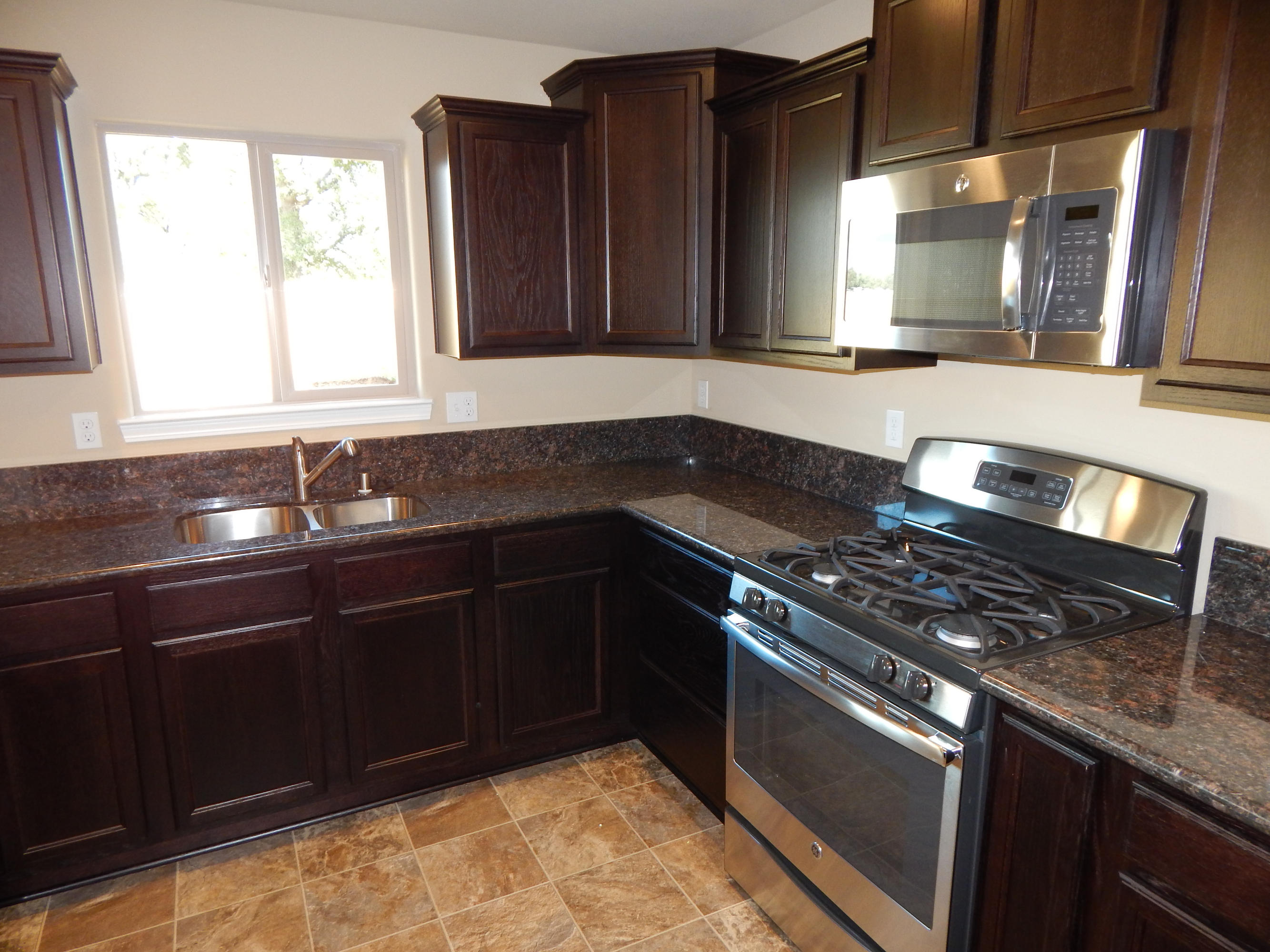 3531 Archer Road Igo, CA 96047 - Photo 25 of 34 a kitchen with granite countertop stainless steel appliances a sink stove and cabinets