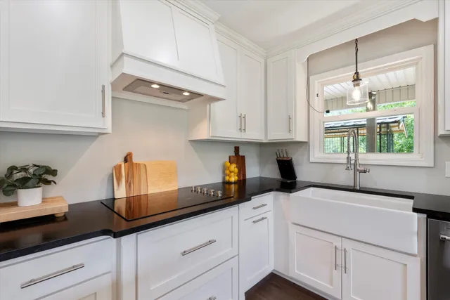 a kitchen with stainless steel appliances granite countertop a sink and a stove