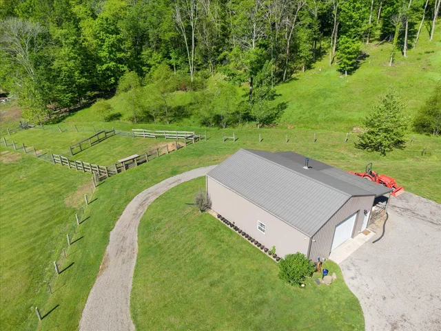 a front view of a house with swimming pool and garden