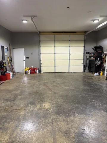 a view of a white house with a big yard and large trees