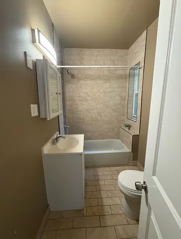 a bathroom with a sink a toilet a bathtub and shower