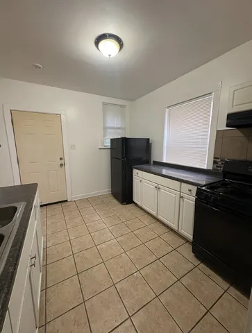 a kitchen with a sink and a stove top oven