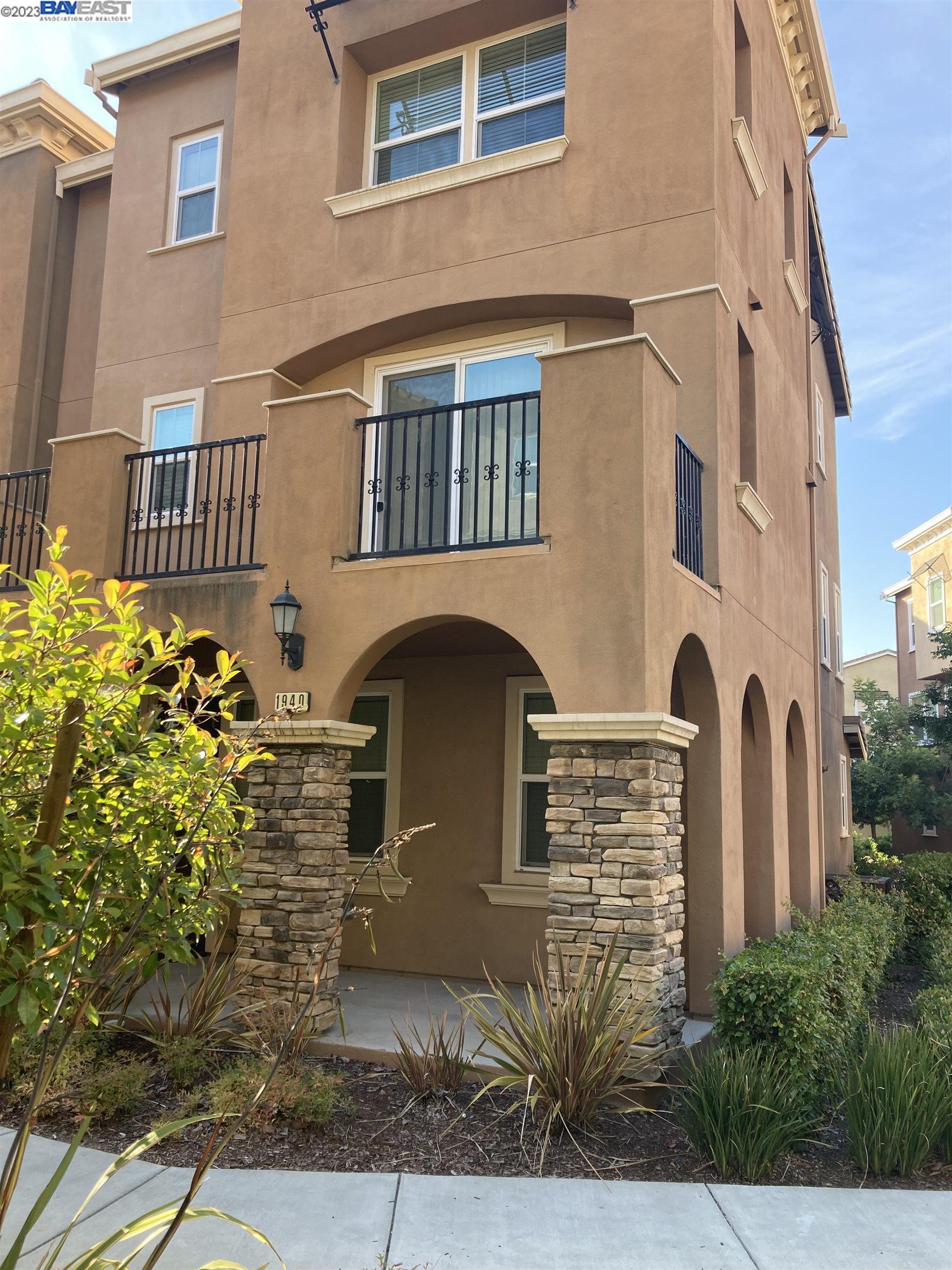 a front view of a house with plants