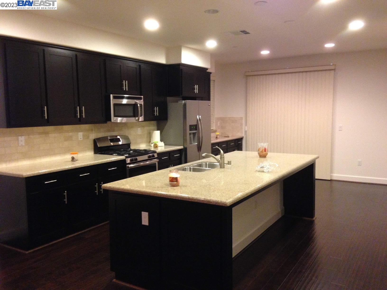 1940 Lee Way Milpitas, CA 95035 - Photo 5 of 11 a kitchen with sink a microwave and cabinets