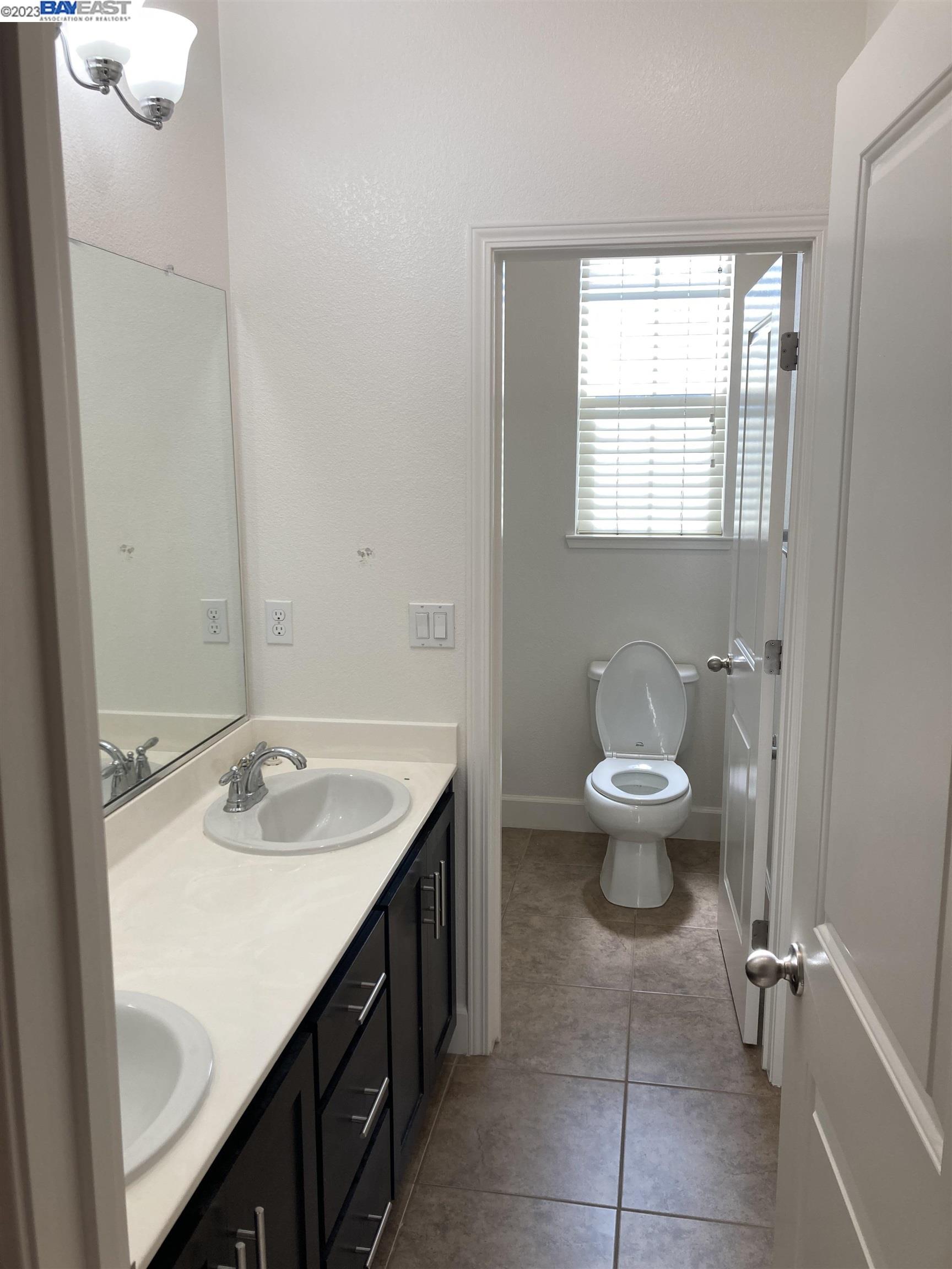 1940 Lee Way Milpitas, CA 95035 - Photo 8 of 11 a bathroom with a sink toilet and window