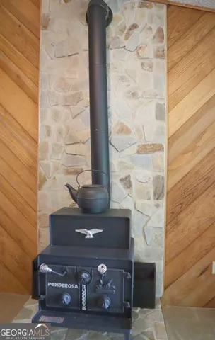 a view of fireplace with a chair