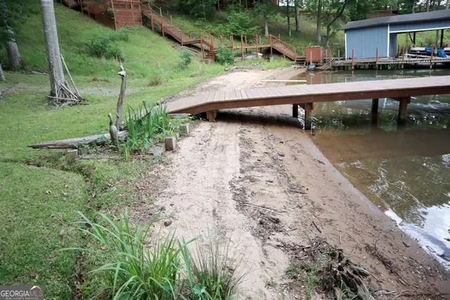 a view of backyard with barbeque grill and outdoor seating