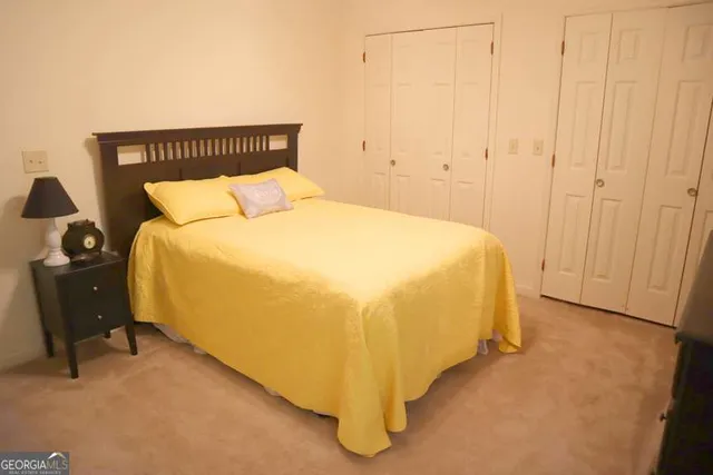 a bed sitting in a bedroom next to a window