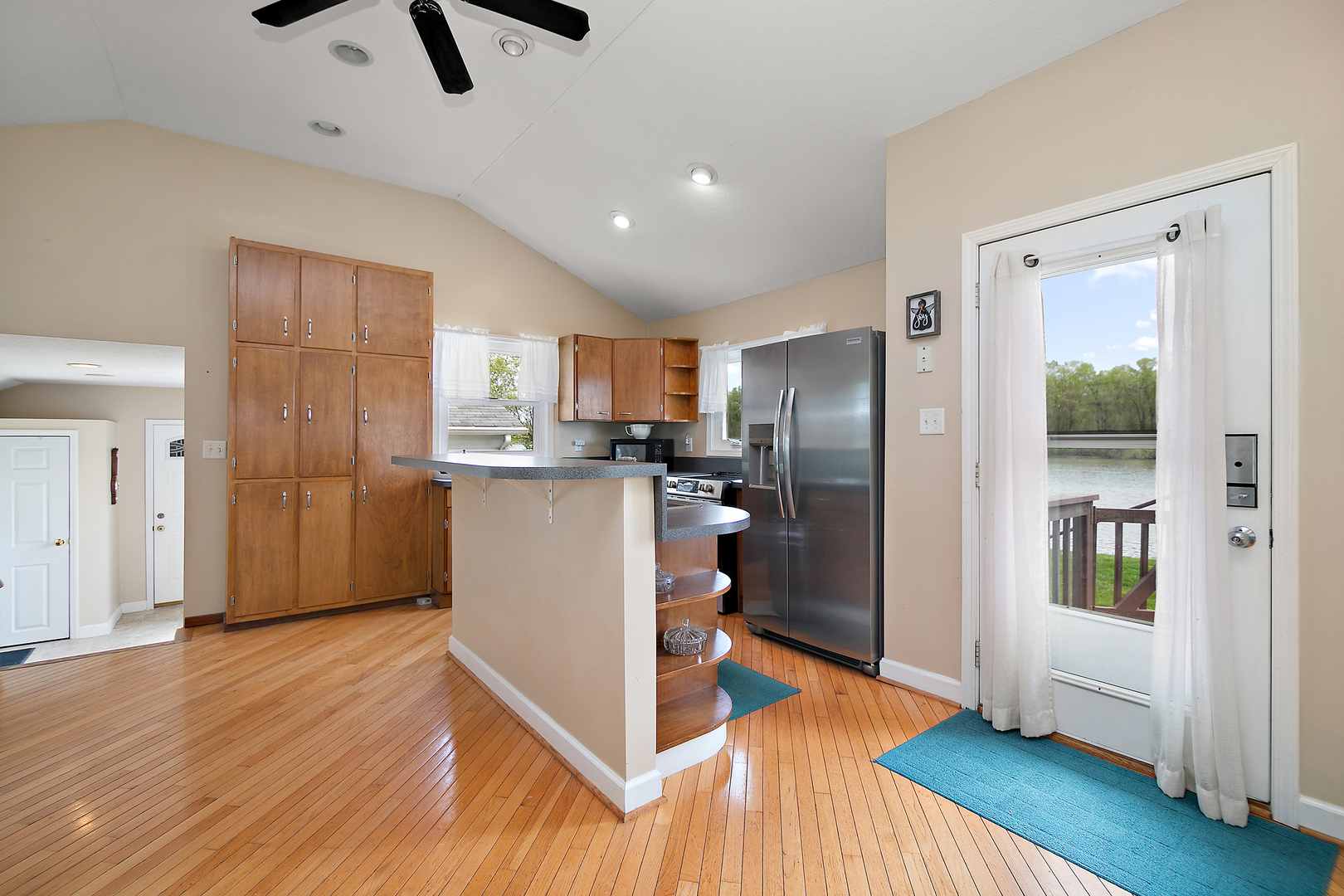 3119 River Road Kankakee, IL 60901 - Photo 15 of 39 a kitchen with stainless steel appliances granite countertop a refrigerator a sink a stove and white cabinets with wooden floor next to windows