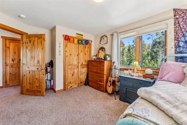 a bedroom with a bed and a workspace