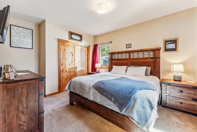 a bedroom with a large bed and a large window