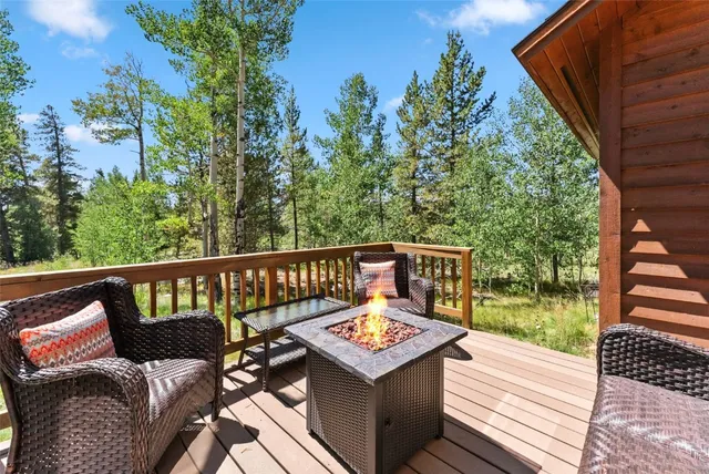 a view of a wooden deck with chairs and an umbrella