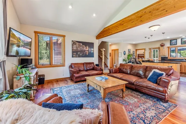 a living room with furniture fireplace and a large window