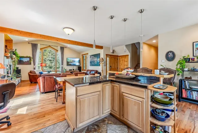 a kitchen with stainless steel appliances granite countertop a stove and a wooden floors