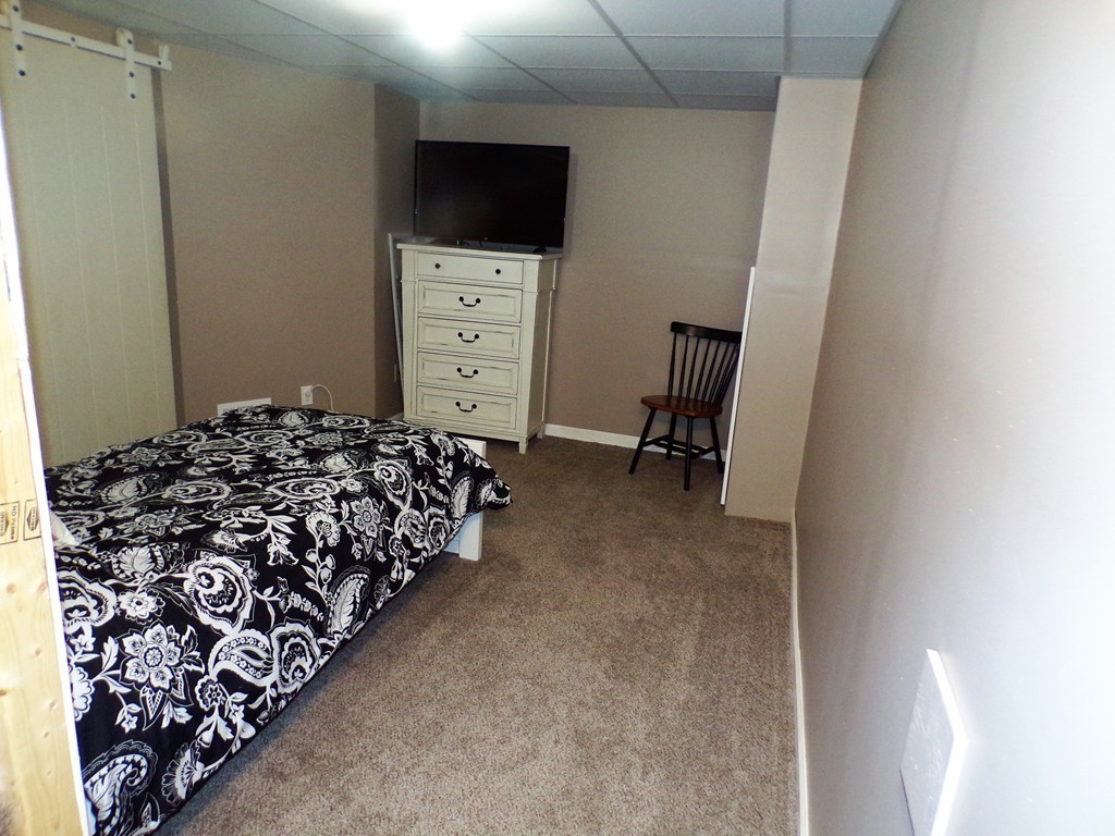 85 Belanger Street, Unit 85 Three Rivers, MA 01080 - Photo 12 of 16 a bed room with a bed and a television