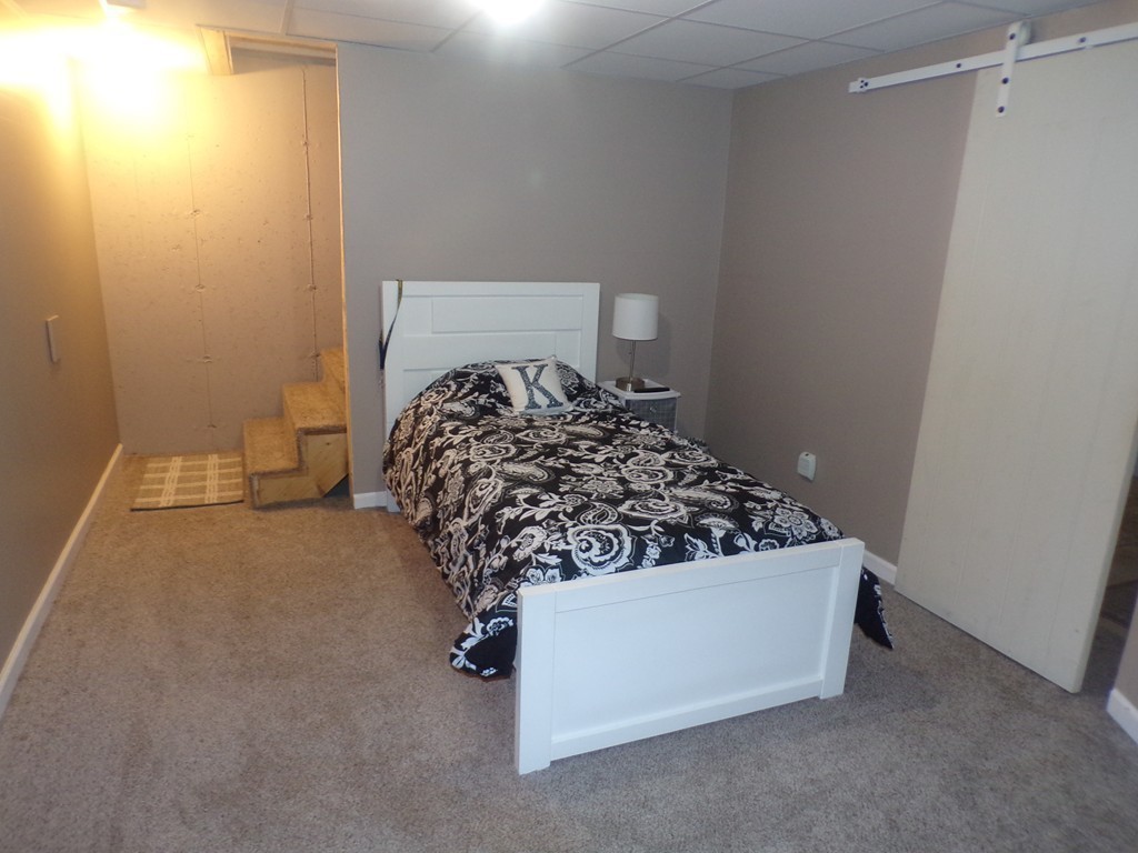 85 Belanger Street, Unit 85 Three Rivers, MA 01080 - Photo 13 of 16 a bed sitting in a bedroom next to a window