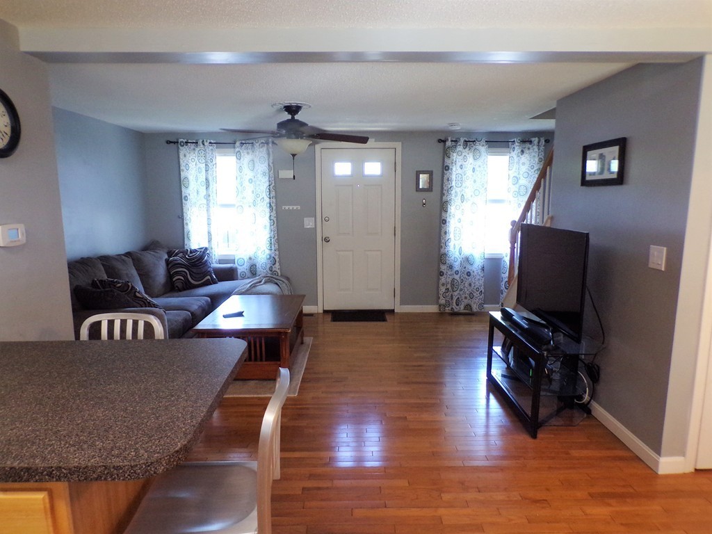 85 Belanger Street, Unit 85 Three Rivers, MA 01080 - Photo 3 of 16 a living room with furniture and a flat screen tv