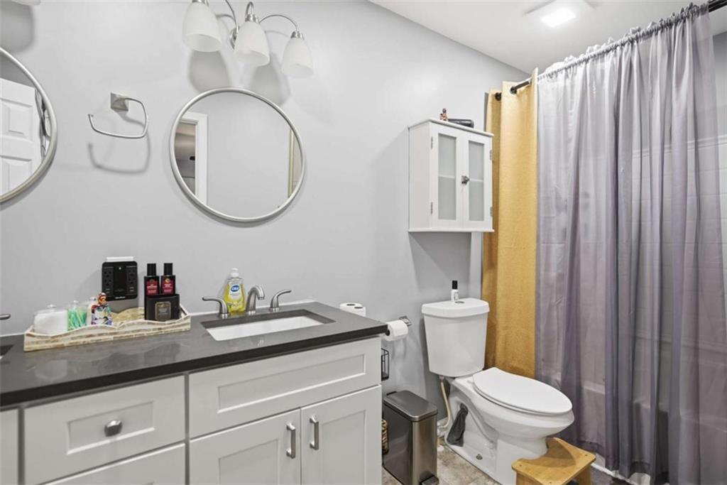 638 Providence Place Southwest Atlanta, GA 30331 - Photo 14 of 22 a bathroom with a granite countertop toilet sink and mirror