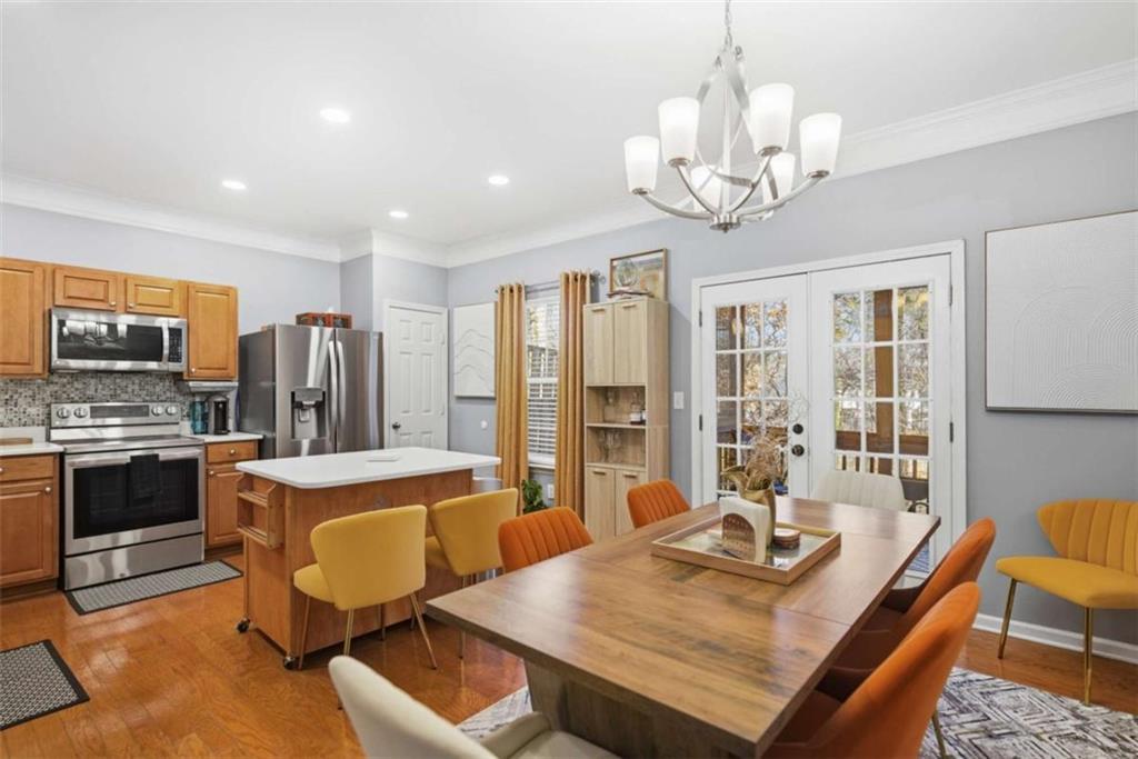 638 Providence Place Southwest Atlanta, GA 30331 - Photo 6 of 22 a view of a dining room with furniture a chandelier and wooden floor