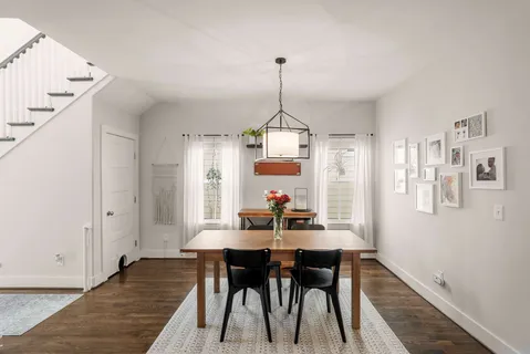 a view of a dining room with furniture window and wooden floor
