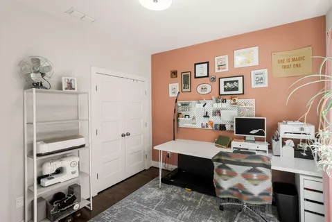 a bedroom with a bed and a desk