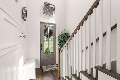 a view of entryway with wooden floor and stairs