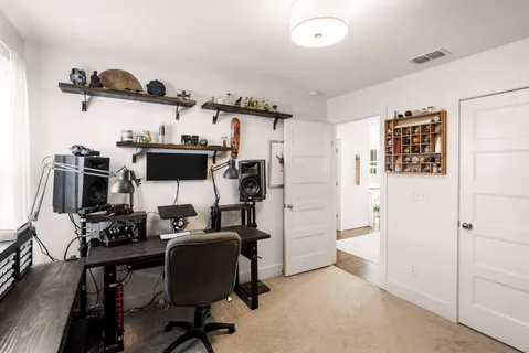 a view of a workspace with furniture and gym equipment