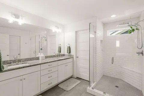a bathroom with a shower sink and mirror
