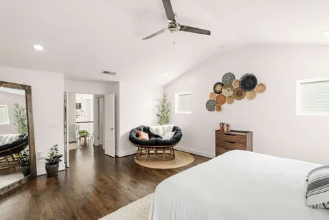 a bedroom with bed and wooden floor