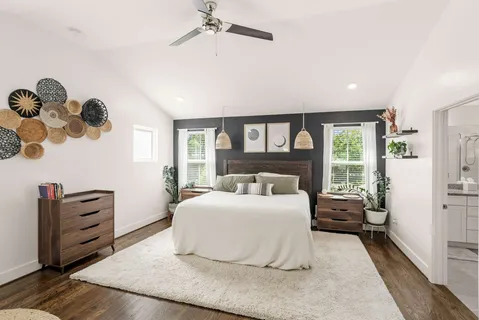 a bedroom with a large bed and a window