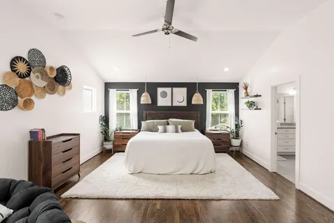 a bedroom with a large bed and a window