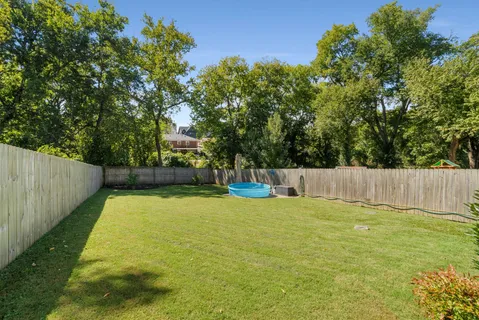 a view of swimming pool with a backyard