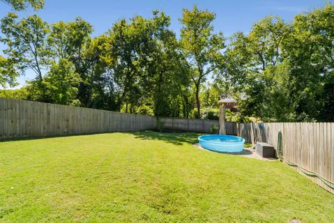 a view of a house with a yard and sitting area