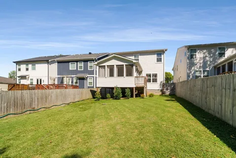 a view of a house with a yard and sitting area