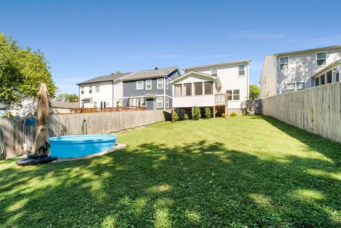 a view of a backyard with wooden fence