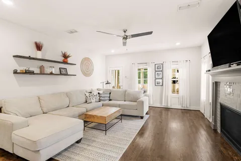 a living room with fireplace furniture and a flat screen tv