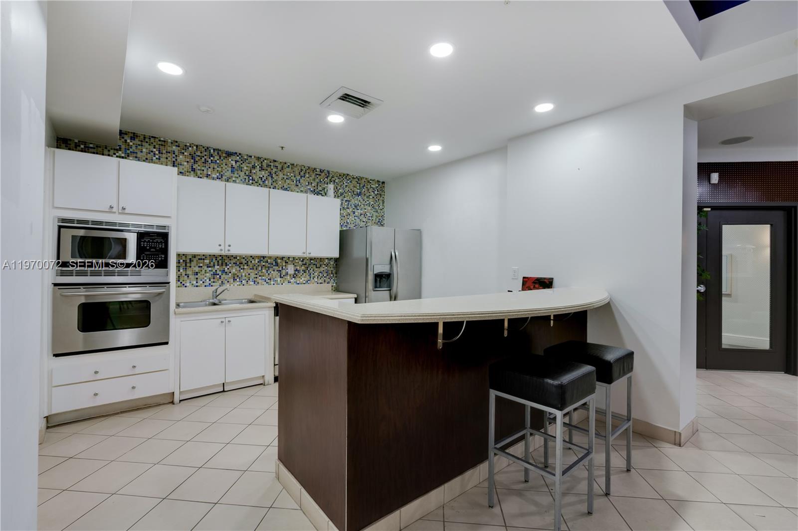 6001 Southwest 70th Street, Unit 221 South Miami, FL 33143 - Photo 5 of 12 a kitchen with a sink cabinets and stainless steel appliances