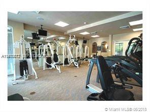 6001 Southwest 70th Street, Unit 221 South Miami, FL 33143 - Photo 8 of 12 a living room with lots of gym equipment