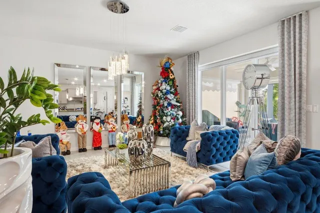 a living room with furniture flowerpot and a chandelier
