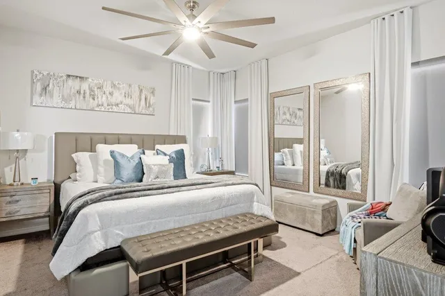 a bedroom with a bed and a chandelier