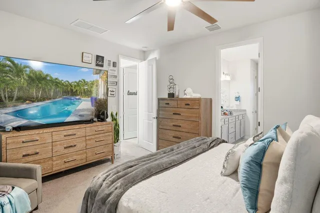 a bedroom with a bed and painting on the wall