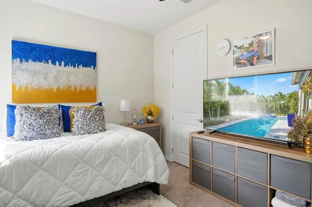 a view of a house with swimming pool and a dining table and chairs in patio