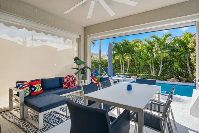 an aerial view of a house with table and chairs and potted plants