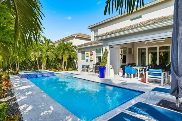 a front view of a house with garden and trees