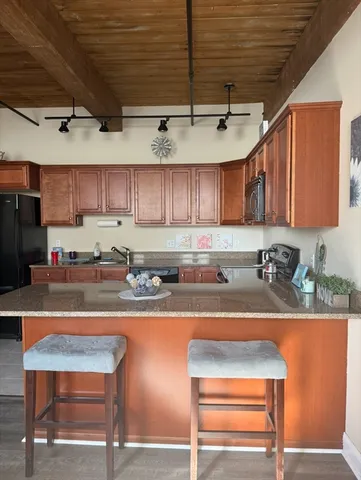 a kitchen with a refrigerator a sink and cabinets
