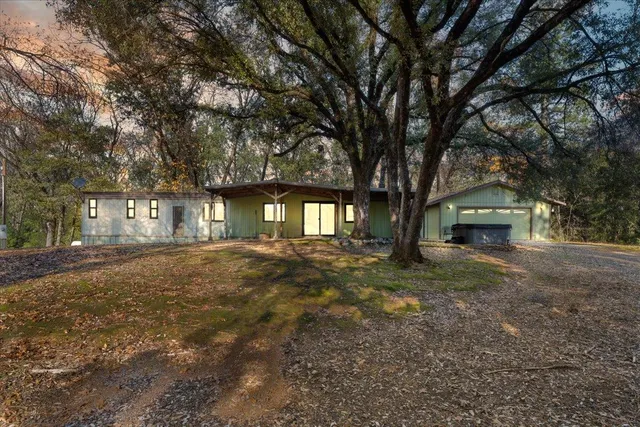 a view of a house with a yard and garage