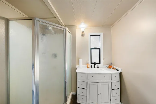 a view of a house with backyard and wooden fence