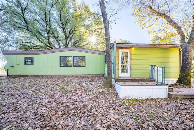 a wooden bench sitting in front of a house