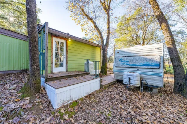 a view of a wooden bench sitting in the forest