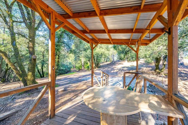 a view of a lush green field with mountains in the background